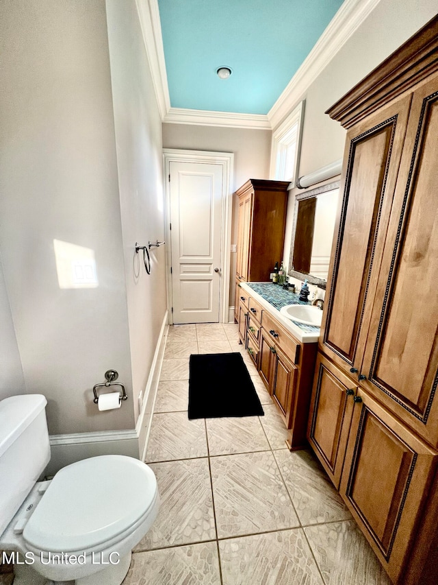 bathroom with ornamental molding, toilet, and vanity