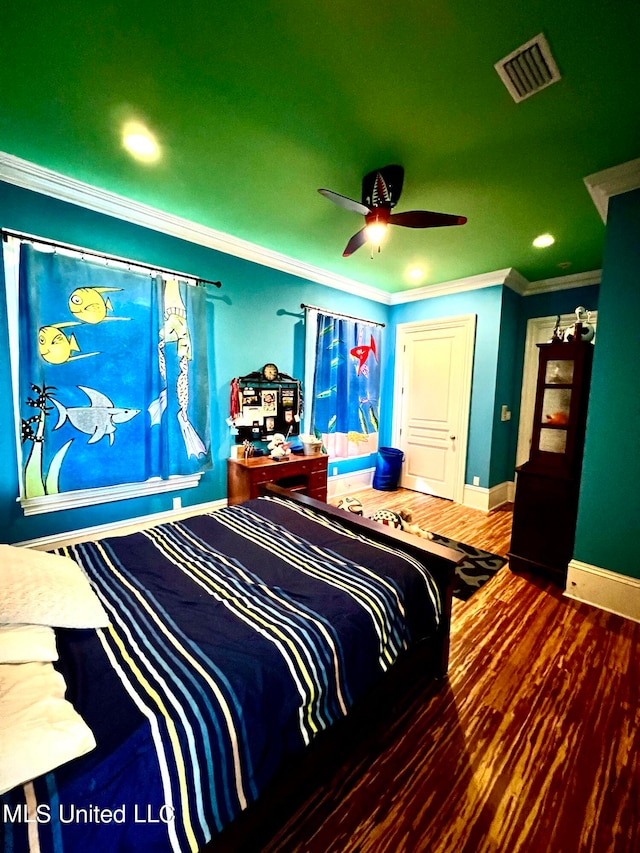 bedroom with dark hardwood / wood-style flooring, ornamental molding, and ceiling fan