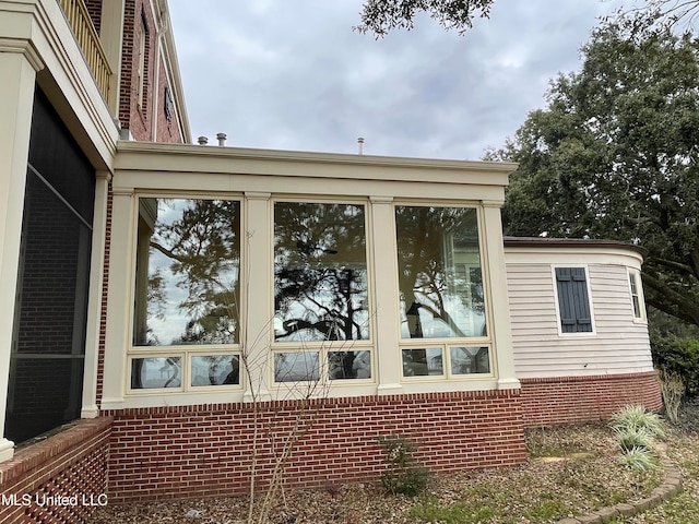 view of side of property with a sunroom