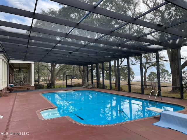 view of swimming pool with a lanai and a patio area