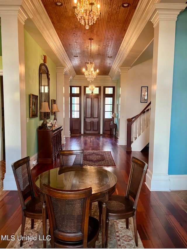 dining space with ornamental molding, decorative columns, and a notable chandelier