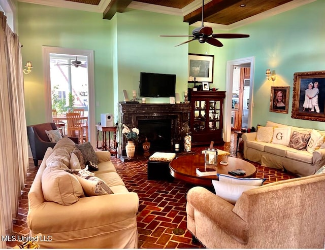 living room with beamed ceiling, crown molding, wooden ceiling, and ceiling fan