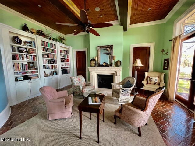 sitting room featuring ornamental molding, beam ceiling, a wealth of natural light, and wooden ceiling