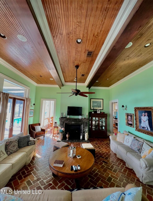 living room featuring ceiling fan, ornamental molding, beam ceiling, and wooden ceiling