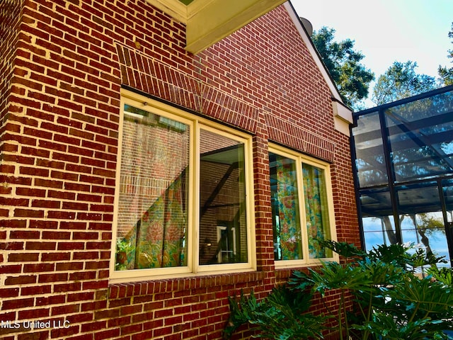 view of side of property with a lanai