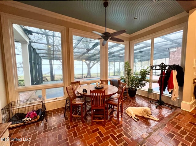 sunroom / solarium with ceiling fan and plenty of natural light