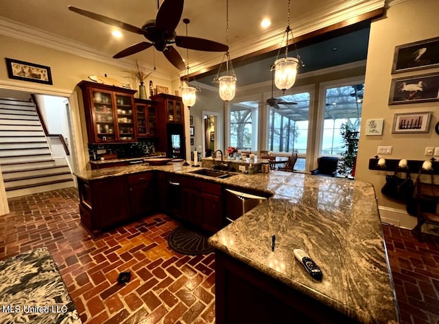 bar with sink, crown molding, hanging light fixtures, light stone countertops, and stainless steel dishwasher