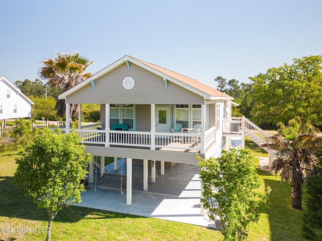 view of front facade with a patio area, a front lawn, and a carport