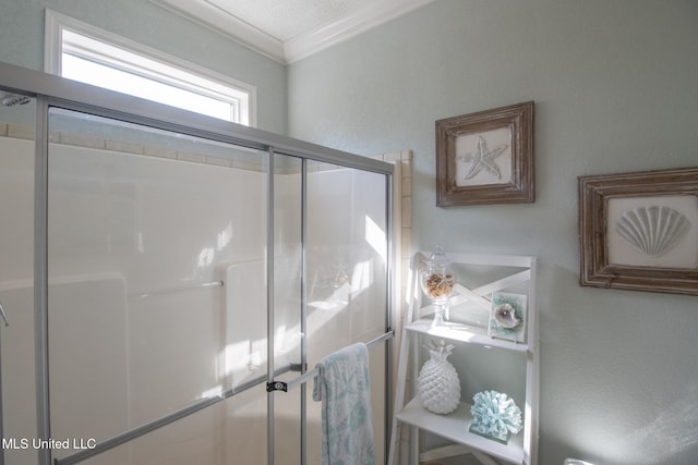 bathroom with a stall shower and ornamental molding