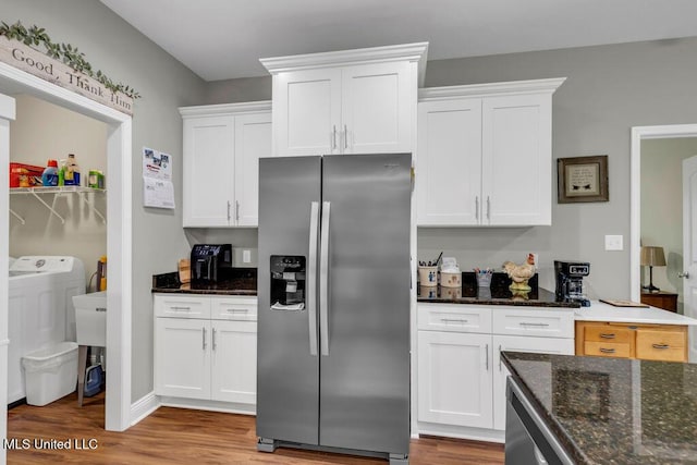 10714 Lilinoe Way, Diamondhead, MS 39525 - kitchen with white cabinets, stainless steel fridge with ice dispenser, and wood finished floors