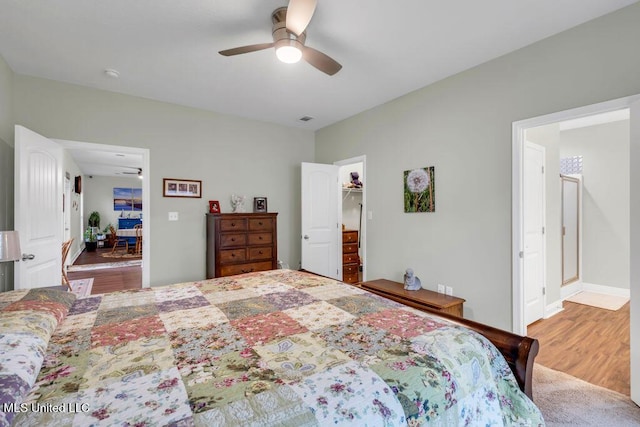 10714 Lilinoe Way, Diamondhead, MS 39525 - bedroom with visible vents, wood finished floors, and ceiling fan