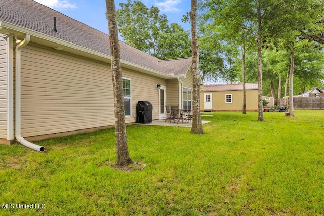 10714 Lilinoe Way, Diamondhead, MS 39525 - back of property with fence, roof with shingles, and a yard