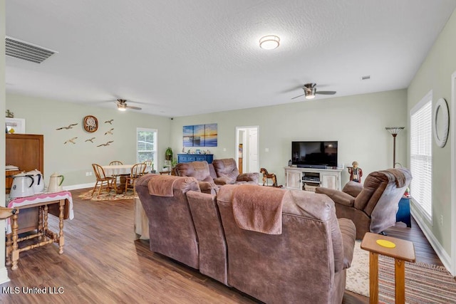 10714 Lilinoe Way, Diamondhead, MS 39525 - living area with ceiling fan, baseboards, wood finished floors, and visible vents