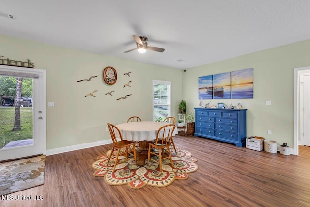 10714 Lilinoe Way, Diamondhead, MS 39525 - dining room featuring wood finished floors, visible vents, a ceiling fan, and baseboards