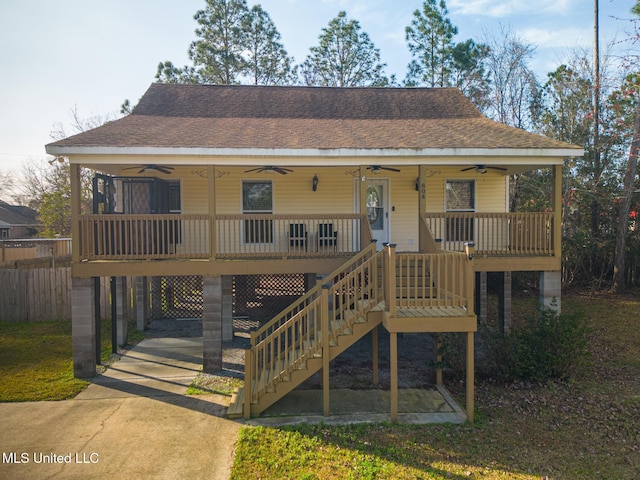 view of front of house featuring a carport, covered porch, and ceiling fan