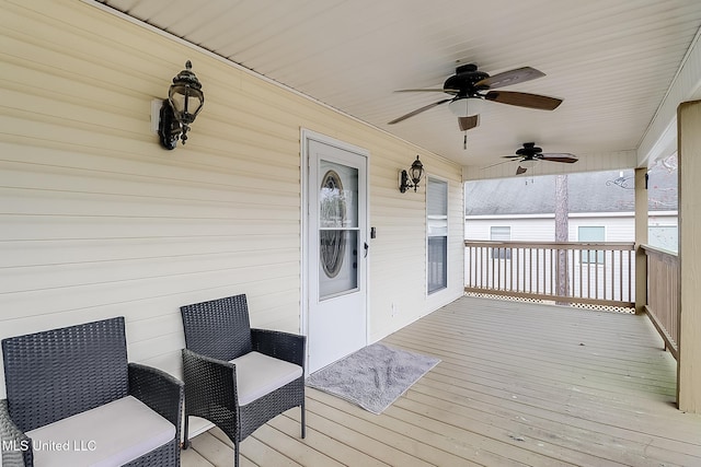 wooden terrace featuring ceiling fan