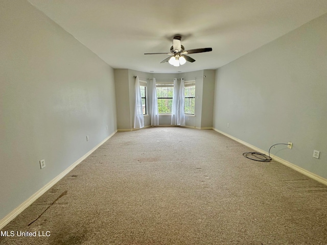 empty room with carpet flooring and ceiling fan