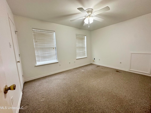 spare room with carpet and ceiling fan