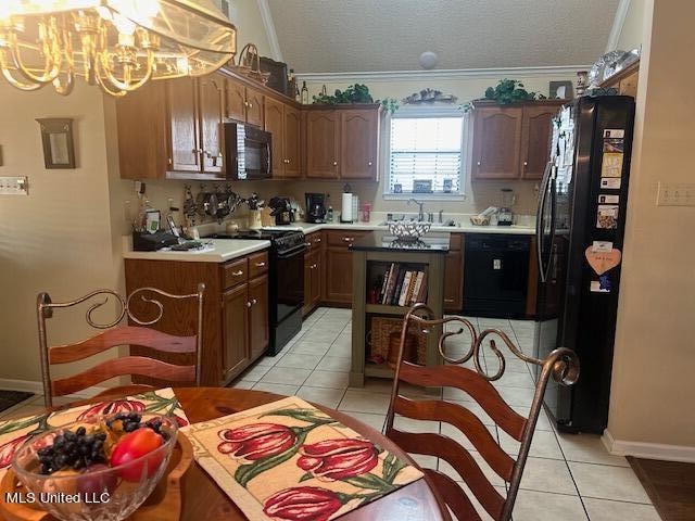 kitchen featuring black appliances, crown molding, a textured ceiling, and light tile patterned floors