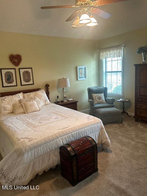 carpeted bedroom featuring ceiling fan