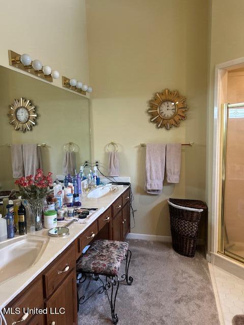 bathroom with a shower with door and vanity