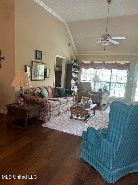 living room featuring a textured ceiling, hardwood / wood-style floors, ceiling fan, lofted ceiling, and ornamental molding