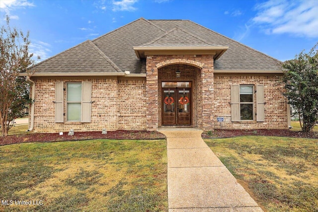 view of front of house featuring french doors and a front yard