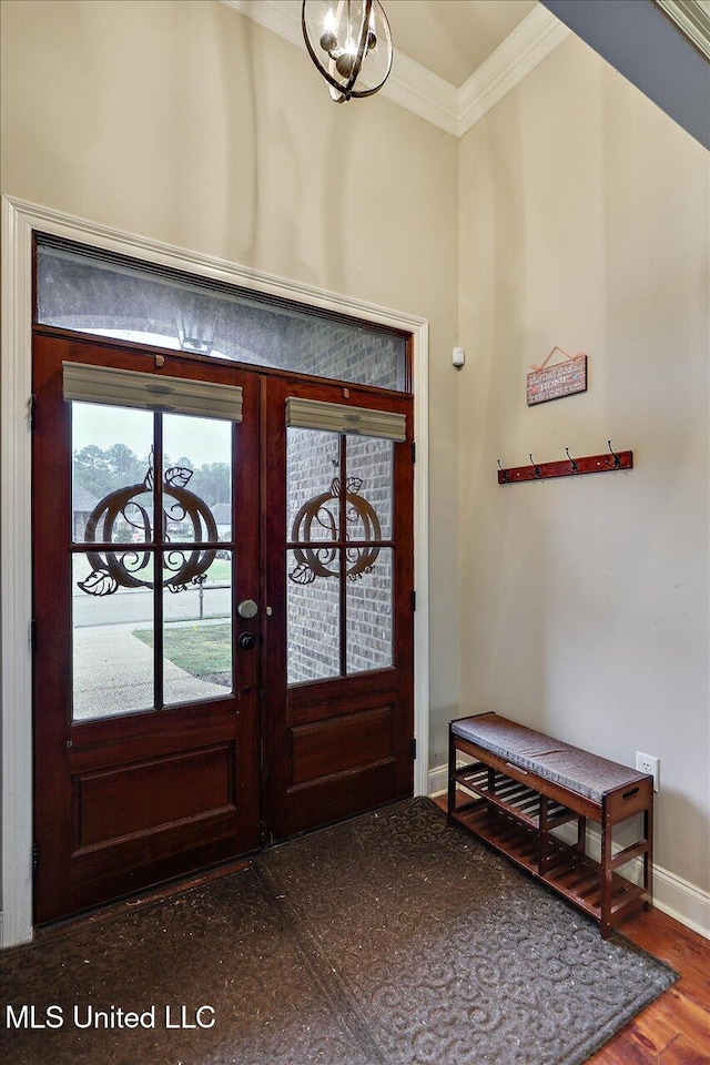 entryway featuring french doors, dark wood-type flooring, and ornamental molding