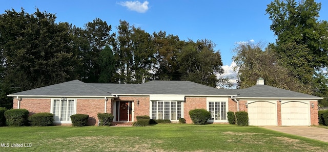 ranch-style home with a front yard and a garage