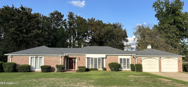507 Reed Dr, Cleveland, MS 38732 - ranch-style house featuring a garage, a front lawn, brick siding, and concrete driveway