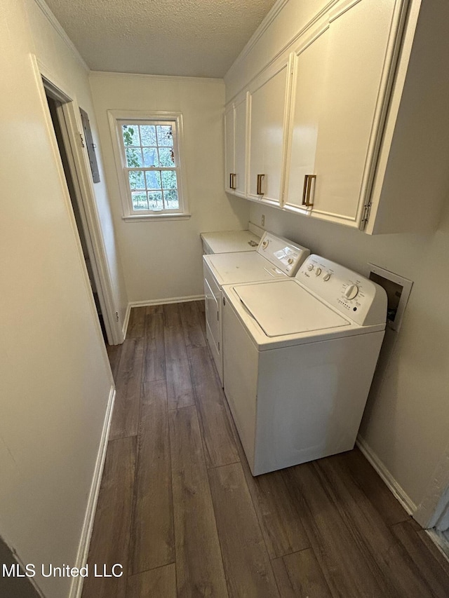 507 Reed Dr, Cleveland, MS 38732 - laundry room with cabinet space, separate washer and dryer, dark wood finished floors, a textured ceiling, and baseboards
