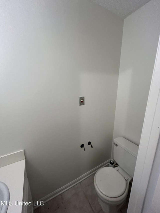 507 Reed Dr, Cleveland, MS 38732 - bathroom with toilet, tile patterned floors, and a textured ceiling