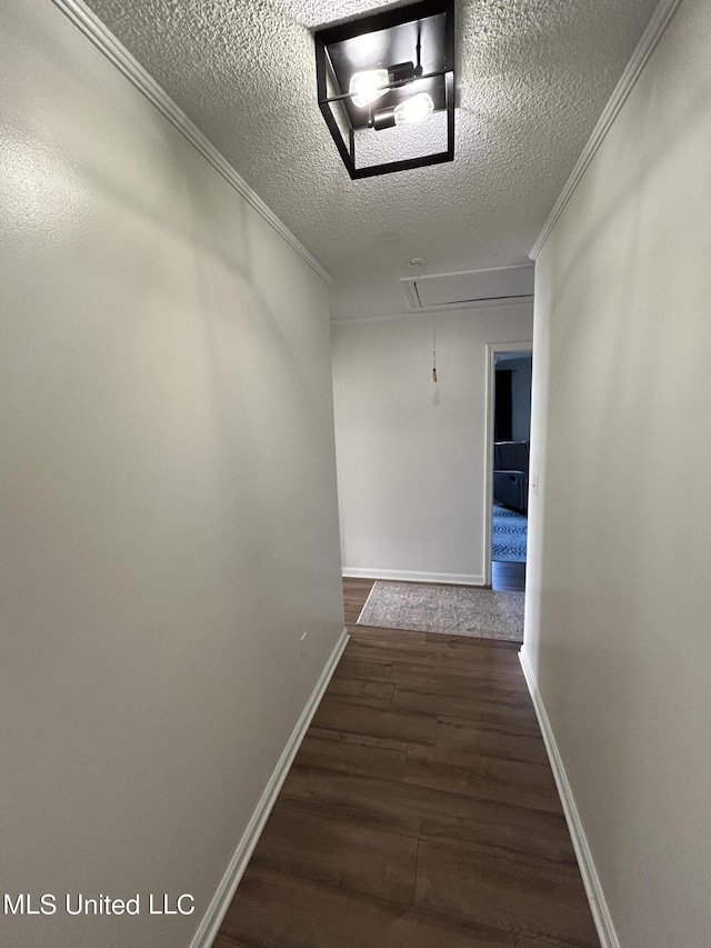 507 Reed Dr, Cleveland, MS 38732 - hallway with attic access, dark wood-style flooring, a textured ceiling, ornamental molding, and baseboards