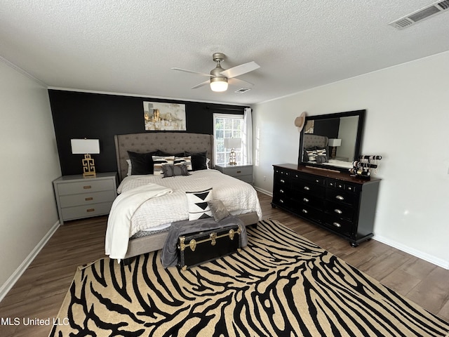 507 Reed Dr, Cleveland, MS 38732 - bedroom with wood finished floors, a textured ceiling, crown molding, ceiling fan, and baseboards