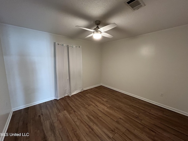 507 Reed Dr, Cleveland, MS 38732 - spare room with dark wood-style flooring, ceiling fan, baseboards, and a textured ceiling