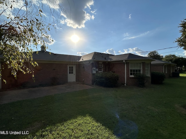 507 Reed Dr, Cleveland, MS 38732 - back of property with brick siding, a lawn, and a patio area