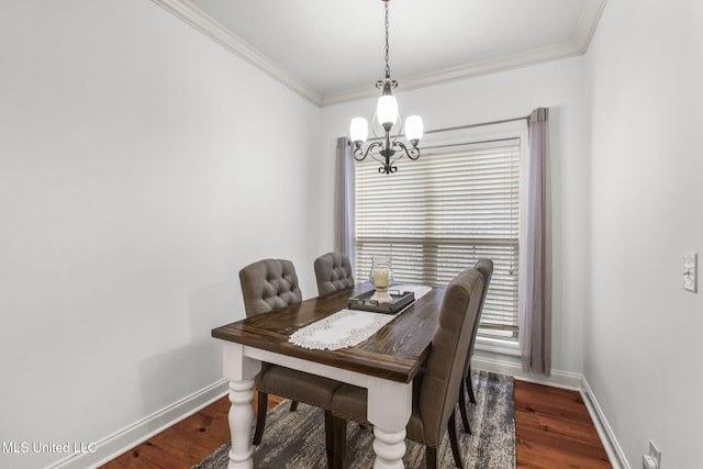 dining room with a chandelier, ornamental molding, baseboards, and wood finished floors