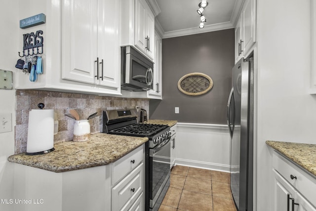 kitchen with white cabinetry, crown molding, light tile patterned flooring, and appliances with stainless steel finishes