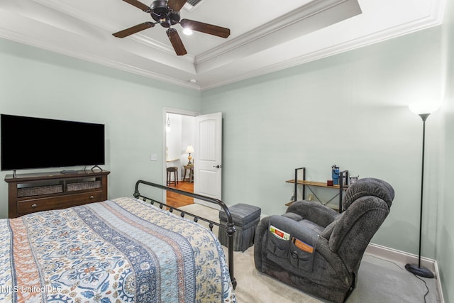 bedroom with a ceiling fan, a raised ceiling, and crown molding