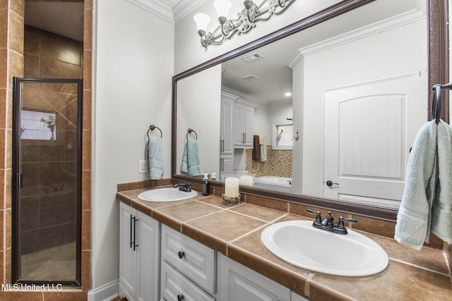 full bath with ornamental molding, a stall shower, and a sink