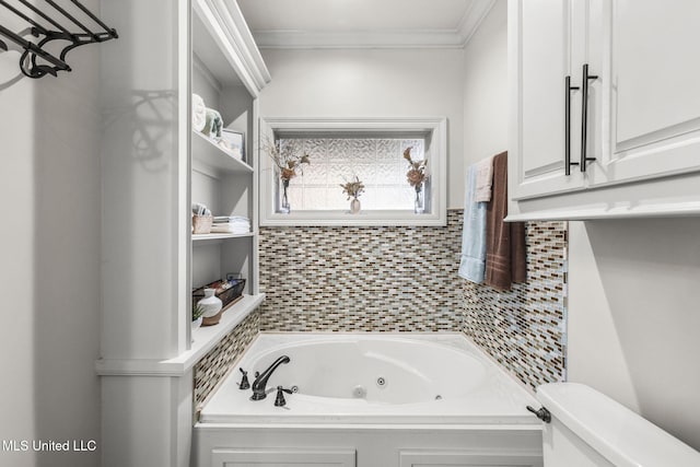 bathroom featuring a jetted tub, toilet, and ornamental molding