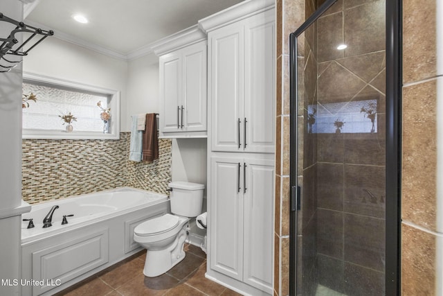 full bathroom with tile patterned flooring, a shower stall, toilet, a garden tub, and ornamental molding