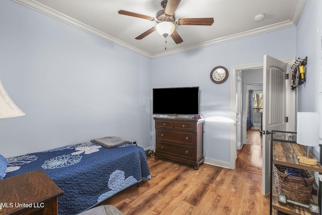 bedroom with baseboards, ceiling fan, crown molding, and light wood finished floors