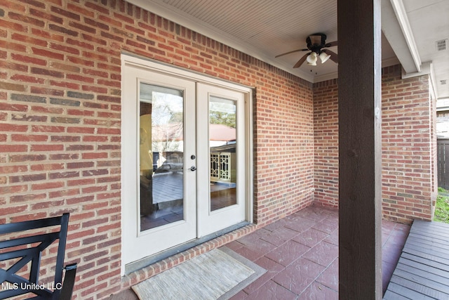 property entrance featuring brick siding, visible vents, french doors, and a ceiling fan