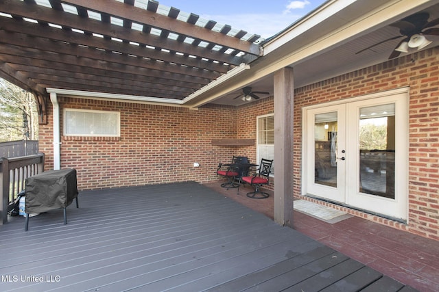 wooden terrace featuring a ceiling fan, french doors, and a pergola