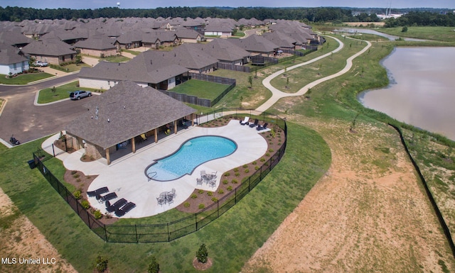 drone / aerial view with a water view and a residential view