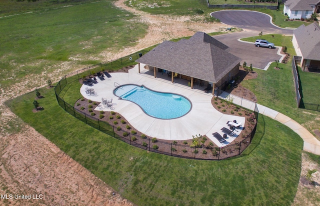 pool with a patio and a fenced backyard