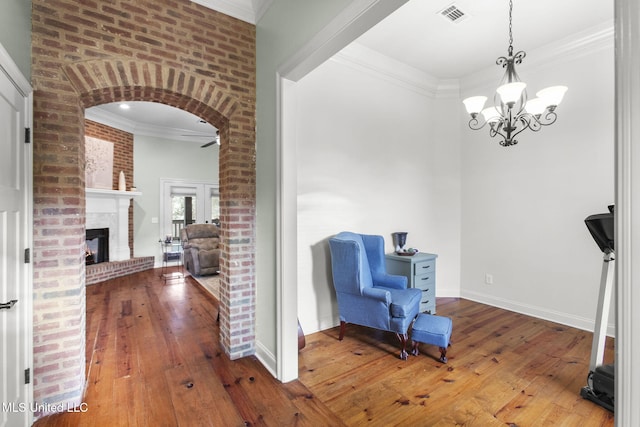 sitting room with visible vents, hardwood / wood-style flooring, and ornamental molding