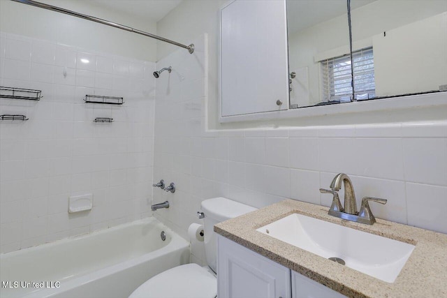 full bathroom featuring tiled shower / bath combo, vanity, backsplash, tile walls, and toilet