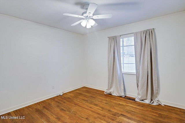 spare room with hardwood / wood-style floors, ceiling fan, and ornamental molding